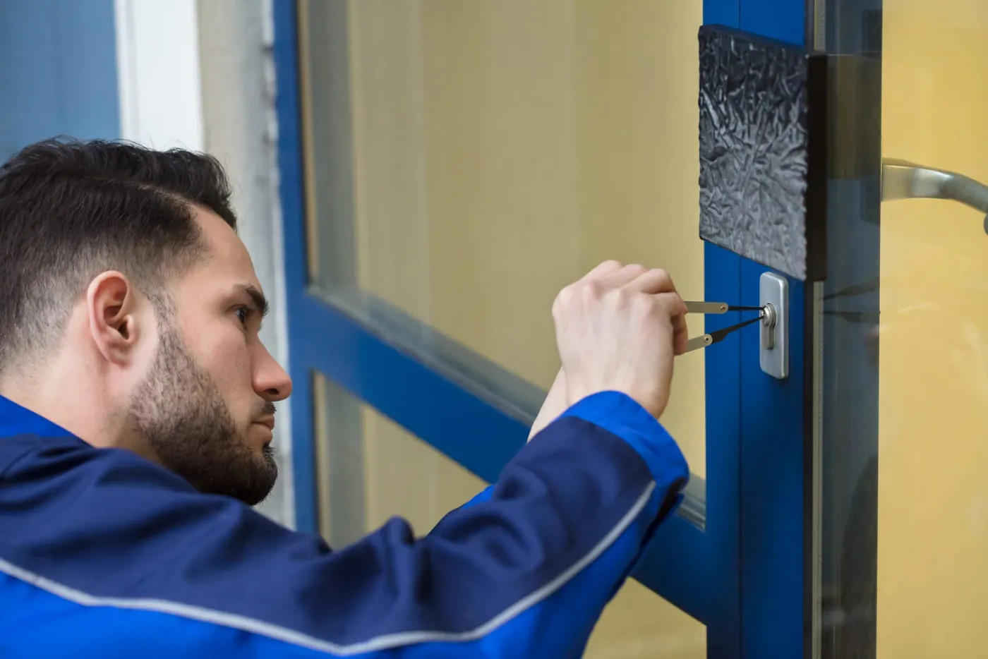 Locksmith working on the entry door of a commercial property