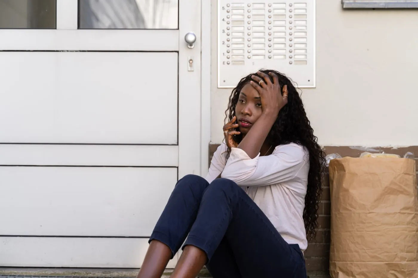 Distressed woman on the phone locked out of her house
